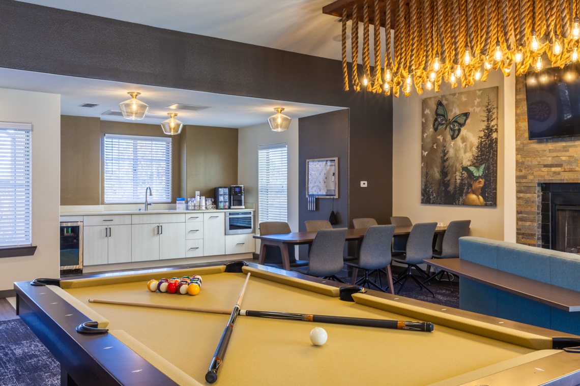 Member clubhouse with chandelier and pool table
