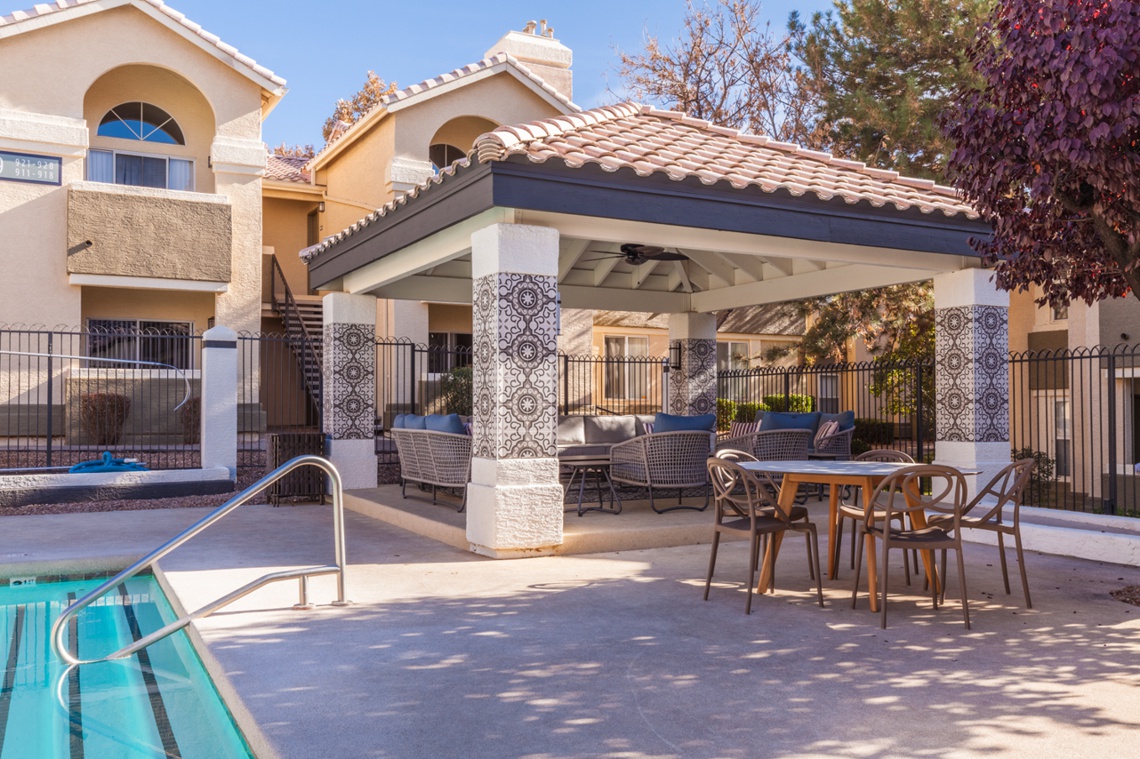 Covered patio and seating area next a pool