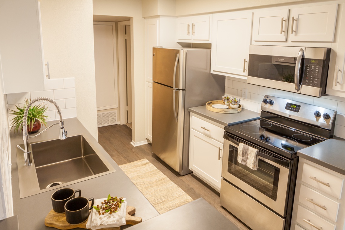 Ottavo apartment unit kitchen with stainless steel appliances