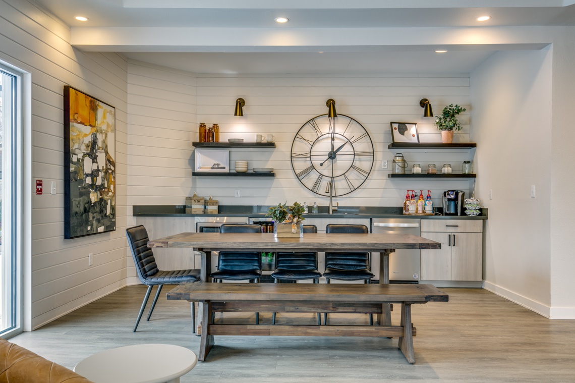 Member clubhouse kitchen area with coffee maker and large dining table