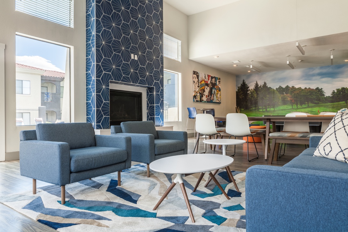 Clubhouse with seating area and large tiled fireplace in the background