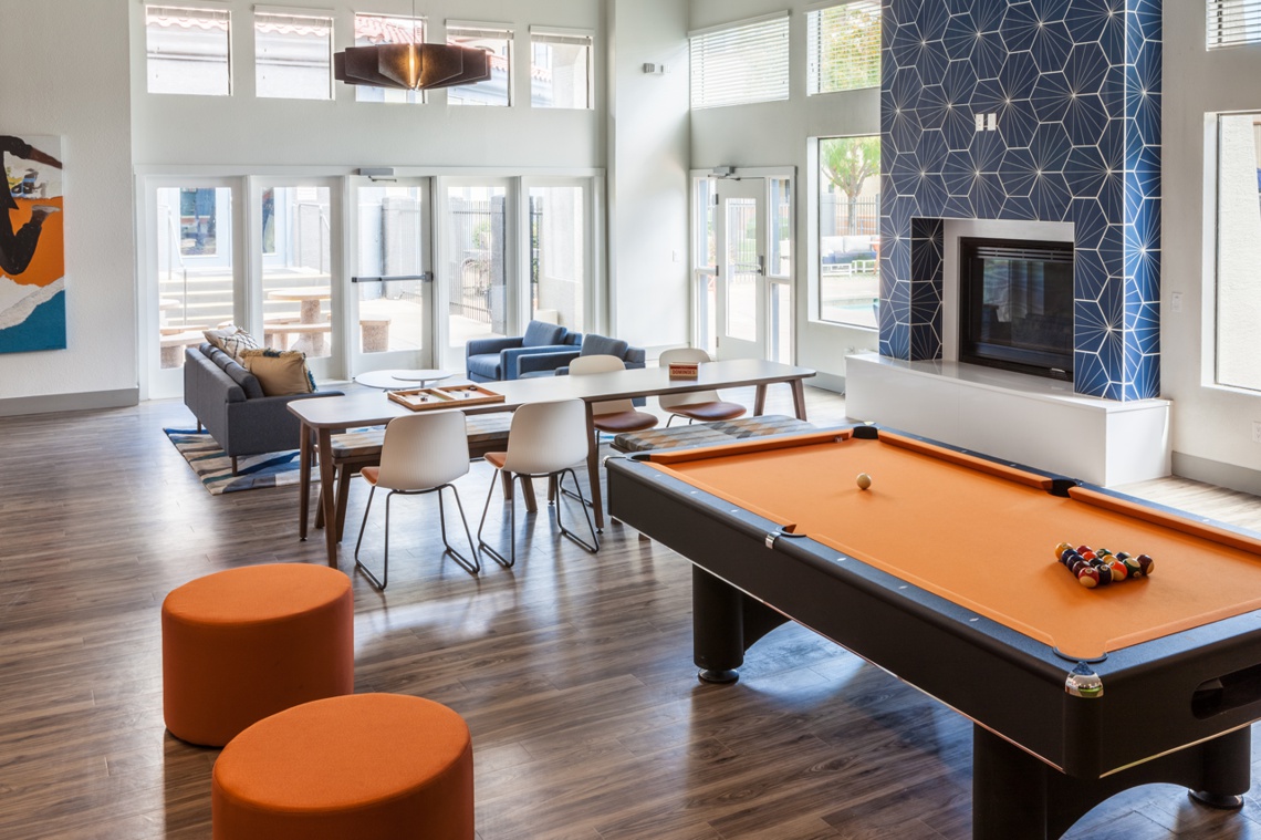 Clubhouse with large tiled fireplace, dining table, and pool table