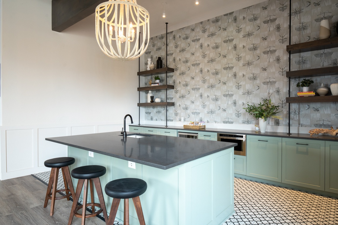 Clubhouse kitchen with tiled backsplash, pendant light, and bar stools