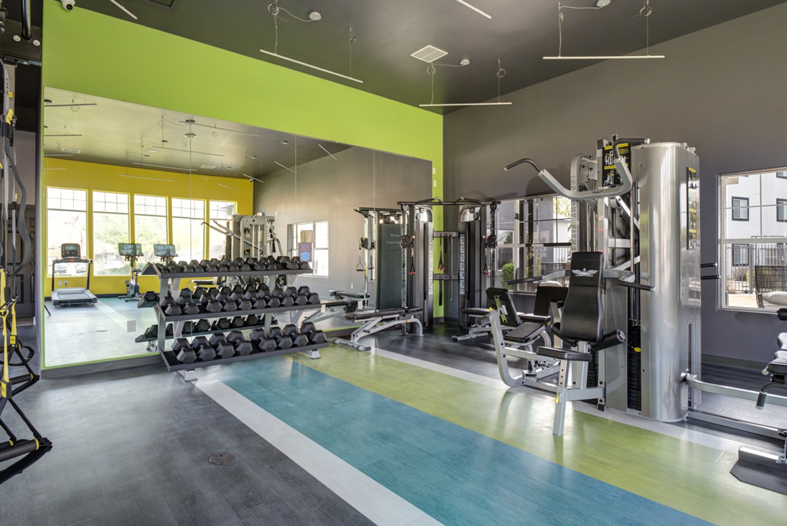 Gym with various workout equipment and free weights